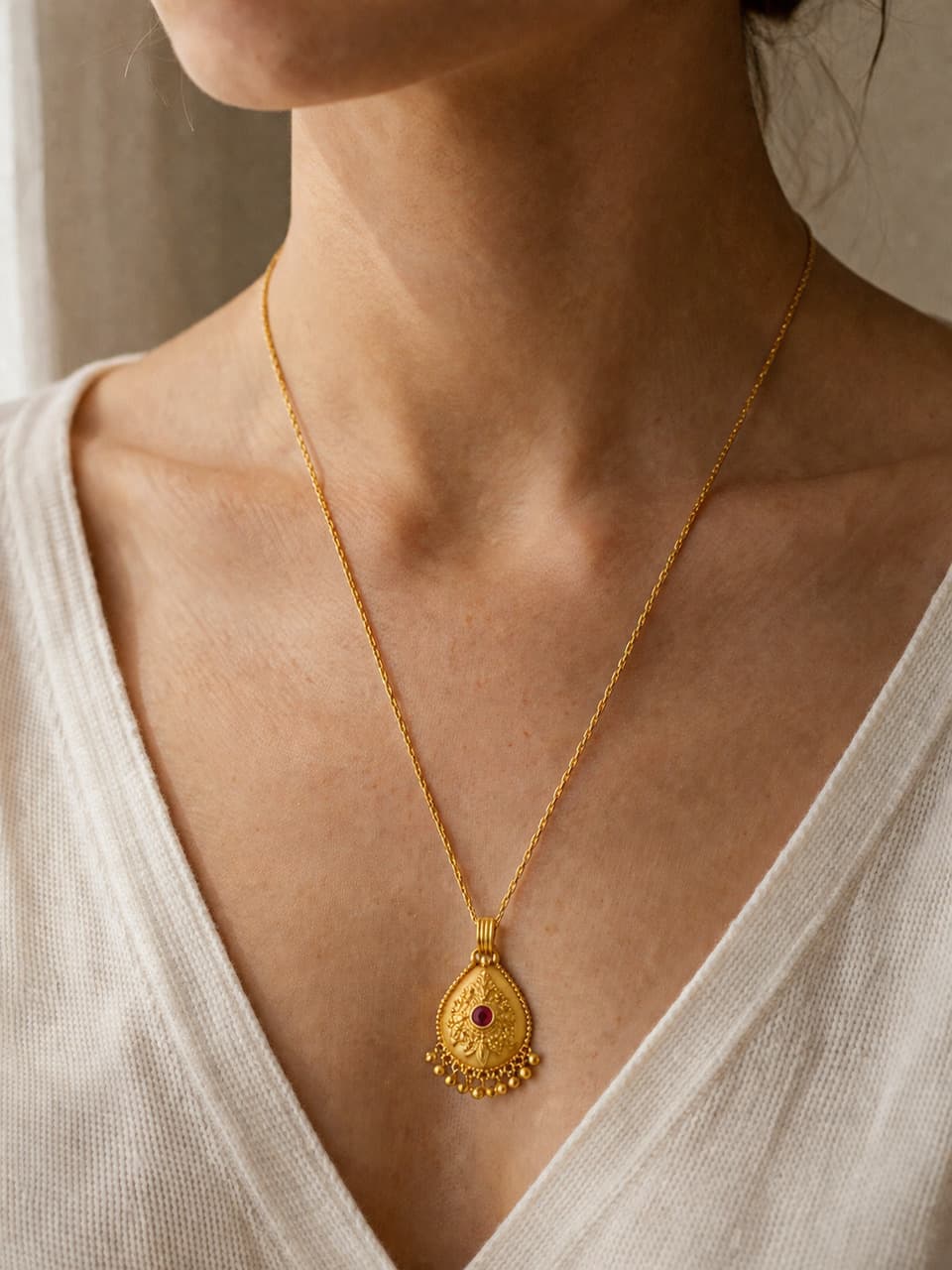 Generated product photo showing the same gold necklace worn in a warm styling scene
